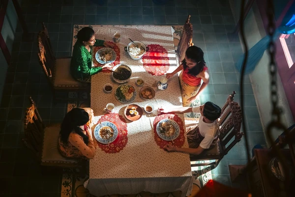 People share meal at table in "Gowok: Javanese Kamasutra".