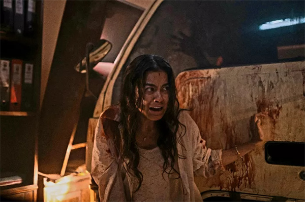 A terrified woman covered in blood in "Abadi Nan Jaya".